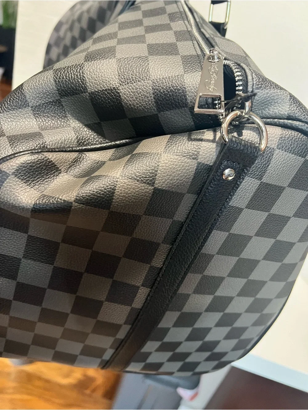 Ed Hardy duffel bag features a black and grey checkered pattern